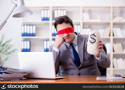 Blindfold businessman sitting at desk in office