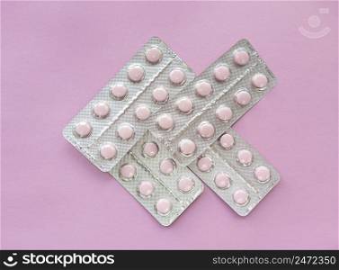 Blisters of soft pink pills on pink background. Monochrome simple flat lay with pastel texture. Medical concept. Stock photography.. Blisters of soft pink pills on pink background. Monochrome simple flat lay with pastel texture. Medical concept. Stock photo.