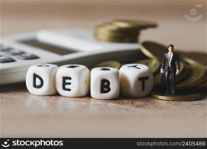Block word debt on pile of coins and calculator with business man, Payment of taxes and of debt to the state, Concept of financial crisis and problems risk management debt exemption loan