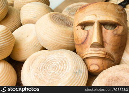 blocks of raw cheese with wooden mask