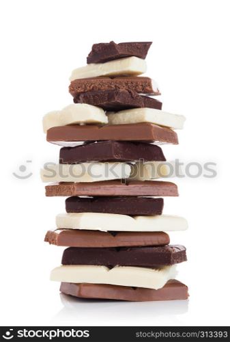 Blocks of white, milk and dark organic chocolate on white background.