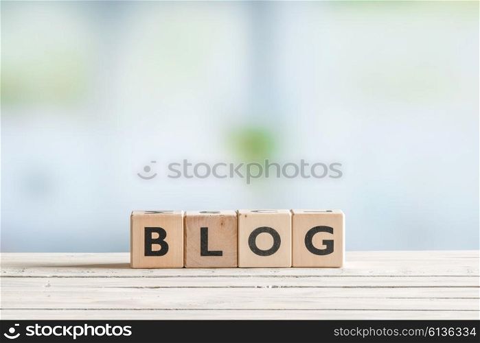 Blog sign on a wooden table with cubes