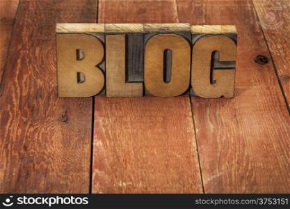 blog word in vintage letterpress wood type against rustic red barn wood table