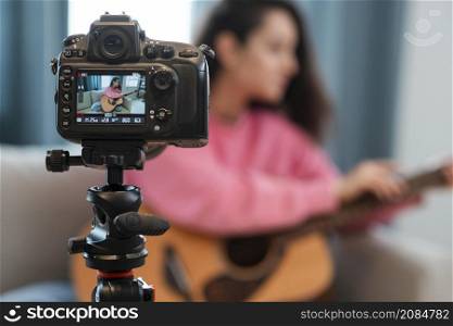 blogger recording video with guitar lesson