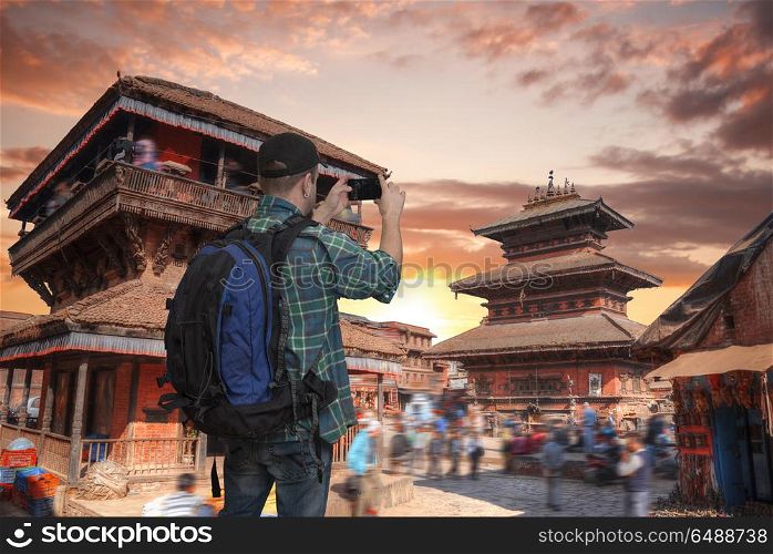 blogger tourist takes pictures on smartphone attractions, Kathmandu valey, Nepal.. Durbar Square in Bhaktapur