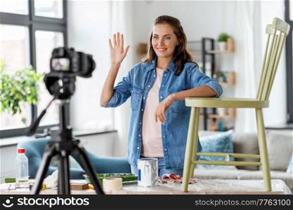 blogging, furniture restoration and home improvement concept - happy smiling woman or blogger waving hand and recording tutorial video about old wooden chair renovation. woman or blogger showing old chair renovation