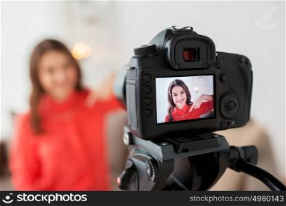 blogging, technology, videoblog, mass media and people concept - happy smiling woman or blogger with camera recording video at home. woman with camera recording video at home