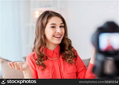 blogging, technology, videoblog, mass media and people concept - happy smiling woman or blogger with camera recording video at home. woman with camera recording video at home