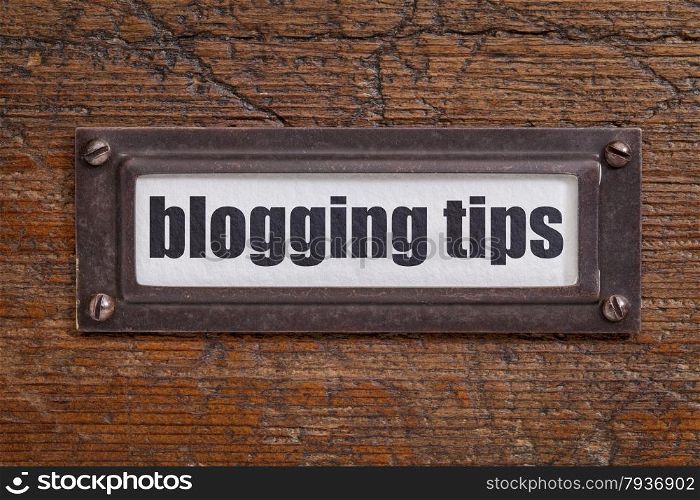 blogging tips - file cabinet label, bronze holder against grunge and scratched wood