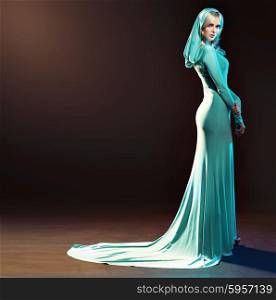 Blond alluring woman dressed in evening gown