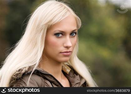 blond and nice girl with long hair in a outdoor portrait