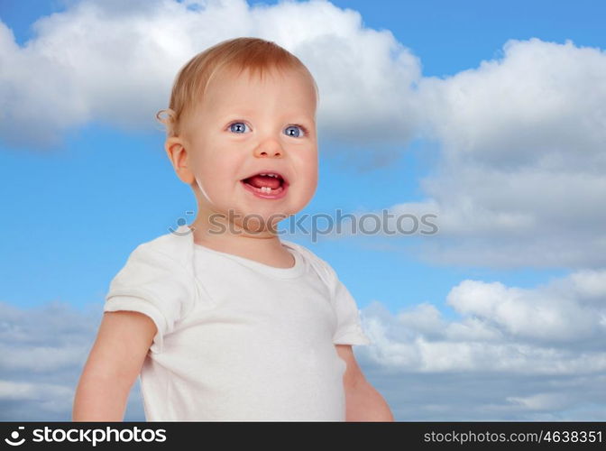 Blond baby with blue eyes with a beautiful sky of background