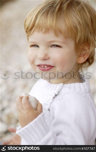 Blond boy smiling portrait on a rolling stones background