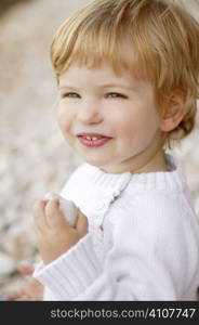 Blond boy smiling portrait on a rolling stones background