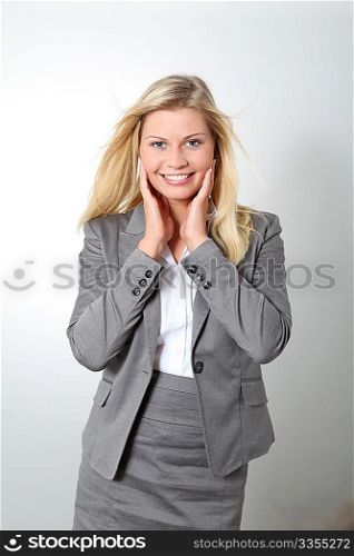 Blond businesswoman doing expressions on white background