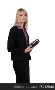 Blond businesswoman holding diary