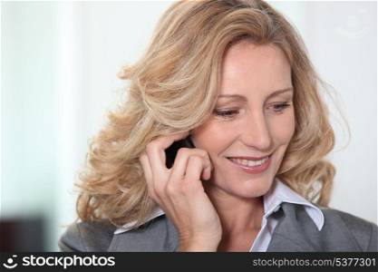 Blond businesswoman on the phone