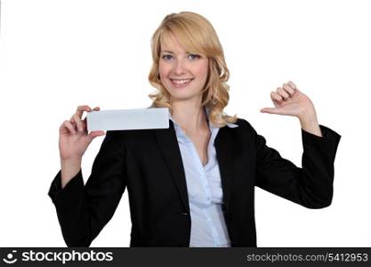 Blond businesswoman pointing at herself