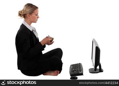 Blond businesswoman sat cross-legged