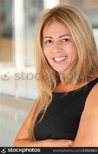 Blond businesswoman standing in hall