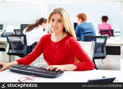 Blond businesswoman working office with computer at desk