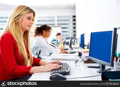 Blond businesswoman young in office with computer in a desk row