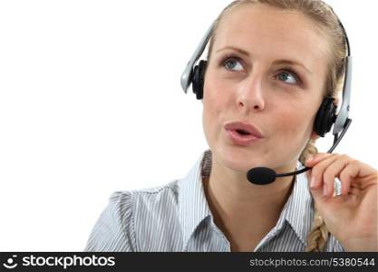 Blond call center worker helping customer over the phone