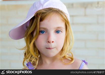 blond child girl gesturing funny with mouth and side pink cap