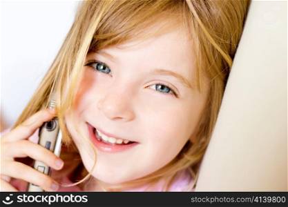 Blond child girl talking mobile telephone smiling happy