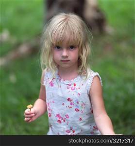 Blond Child Holding Flower at Moorea in Tahiti
