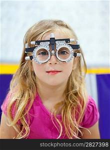 blond children girl with optometrist diopter glasses smiling