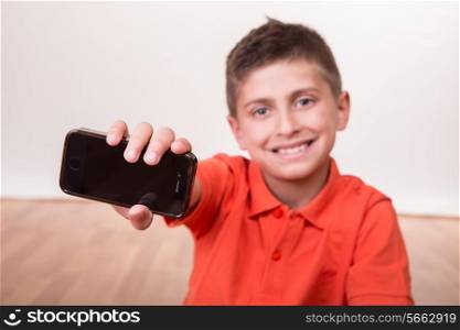 Blond cute boy holding his own cellphone