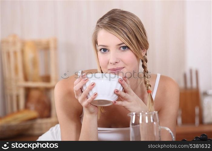 Blond drinking from bowl