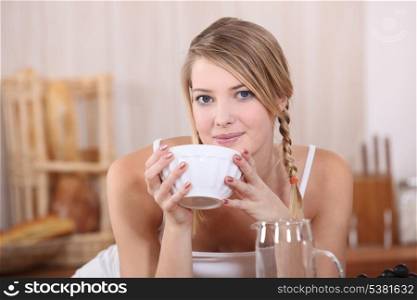 Blond drinking from bowl
