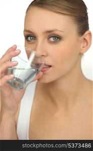 Blond drinking glass of water