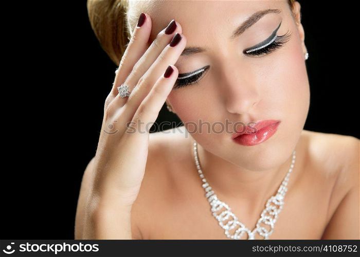 Blond elegant thinking fashion woman with jewelry on black