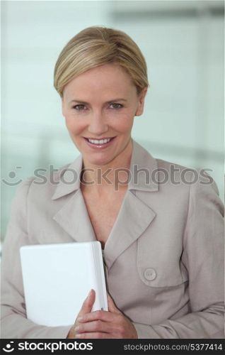Blond executive holding laptop computer