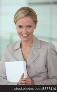 Blond executive holding laptop computer