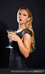 Blond fashion woman drinking vermouth cup on black background