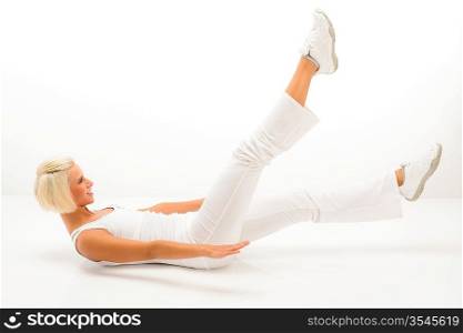 Blond fitness woman doing abdominal exercises smiling at gym workout