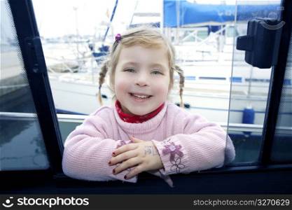 blond funny smiling little girl boat mediterranean marina window