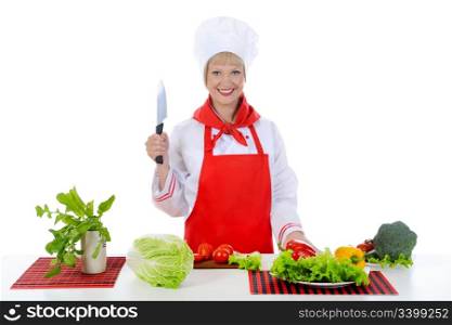 blond girl cuts the tomatoes in the kitchen. Isolated on white background