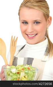 Blond girl eating green salad