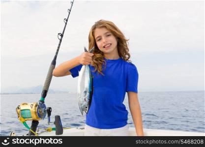 Blond girl fishing bluefin tuna trolling in Mediterranean sea catch and release