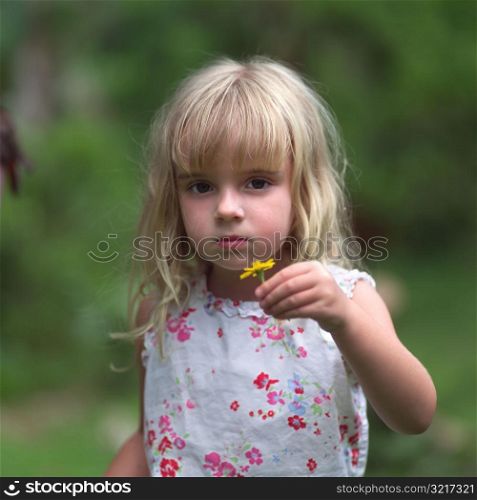 Blond Girl Holding Yellow Flower at Moorea in Tahiti