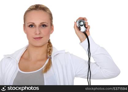 Blond girl in sportswear showing stopwatch