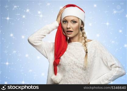 blond girl in white dress with a long christmas hat looking in camera with fake stars on background