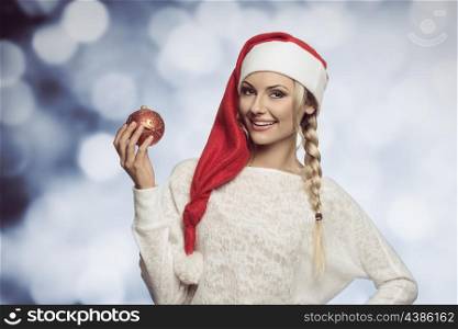 blond girl in white dress with a long christmas hat looking in cameara