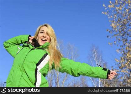 Blond girl in winter outfit enjoys the sun