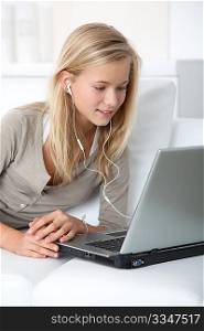 Blond girl listening to music on internet